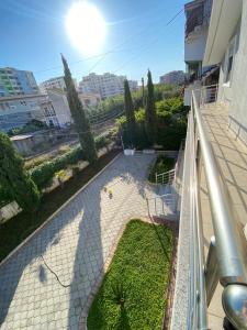 a balcony of a building with a garden at Guest House Twins in Durrës