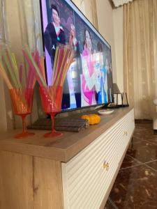 a flat screen tv sitting on top of a dresser at Guest House Twins in Durrës