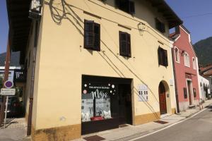 a building with a window on the side of a street at New boutique apartments house Gabrijela Mrak in old Tolmin in Tolmin