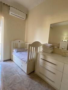 a bedroom with a bed and a dresser and a mirror at Guest House Twins in Durrës +43 photos