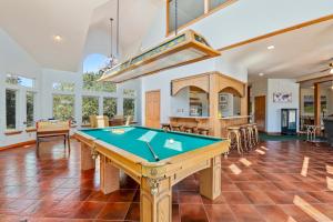 a living room with a pool table in it at Sailors Cove in Corolla