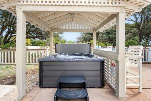 a barbecue under a pergola on a patio at Sailors Cove in Corolla