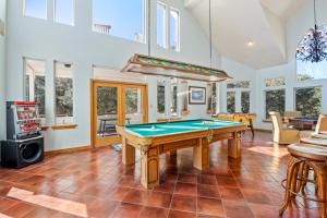 a living room with a pool table in it at Sailors Cove in Corolla +81 photos