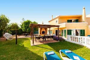 a backyard with a gazebo and a table and chairs at Villa Casablanca by Algarve Vacation in Portimão +54 photos