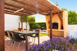 a patio with a table and a fireplace at Villa Casablanca by Algarve Vacation in Portimão