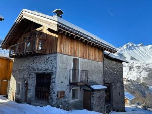 a house in the snow with a balcony at Chalet de Luxe à Saint Martin de Belleville : Spa, Sauna, Proche Pistes et Commerces - FR-1-452-199 in Saint-Martin-de-Belleville