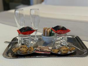 a tray with two wine glasses on a table at Villa Marengo Guest House in Spinetta Marengo