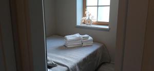 a stack of towels sitting on a bed in a room at Villa by the Baltic Sea in Palanga
