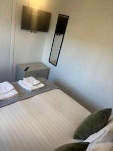 a bedroom with a bed with towels on it at NEW - 3 Bedroom House in East Kilbride in East Kilbride