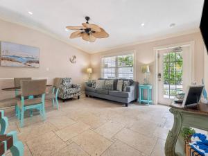a living room with a couch and a ceiling fan at Villa La Esperanza-Holmes Beach in Anna Maria Island