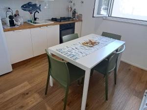 a kitchen with a white table and chairs at Il Boschetto in Santo Spirito