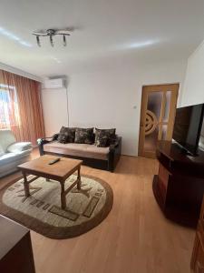 a living room with a couch and a coffee table at Florence apartament in Constanţa +2 photos
