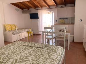 a room with a bed and a table and a kitchen at Heavenly View Yellow in Lákhion