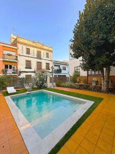 a swimming pool in front of a building at Historic House at Can Quintana by Casa de Elena in Pineda de Mar