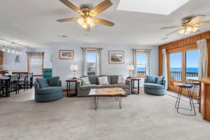 a living room with a couch and chairs and a table at The Lily Pad in Nags Head