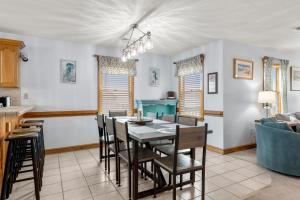 a kitchen and dining room with a table and chairs at The Lily Pad in Nags Head