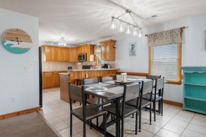 a kitchen and dining room with a table and chairs at The Lily Pad in Nags Head