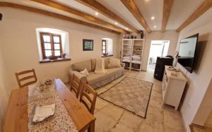 a living room with a couch and a table at Apartma Pri Lukšu in Tolmin