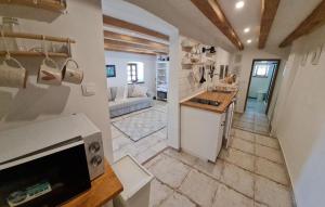 a kitchen with a sink and a living room at Apartma Pri Lukšu in Tolmin