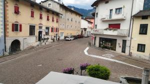 an empty street in a town with buildings at Appartamenti Piazza Vecchia in Caldonazzo