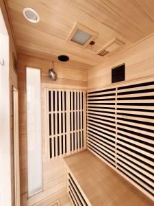 a sauna with wooden walls and a wooden ceiling at Charme, lumiere, jardin et sauna! in Étretat