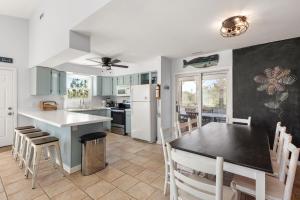 a kitchen and dining room with a table and chairs at Wishing Whale in Corolla