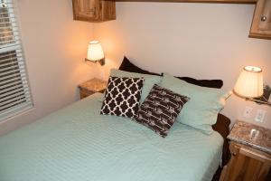 a bedroom with a bed with blue sheets and pillows at Canyonlands Cabin #19 in Moab