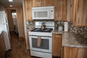 a kitchen with a stove and a microwave at Canyonlands Cabin #19 in Moab