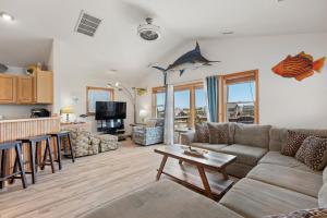a living room with a couch and a table at Marlin Manor by Village Realty in Nags Head
