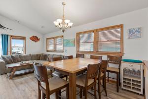 a dining room with a table and a couch at Marlin Manor by Village Realty in Nags Head +36 photos