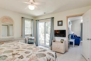 a bedroom with a bed and a flat screen tv at My Happy Place by Village Realty in Corolla +23 photos
