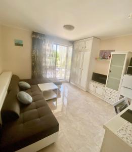a large living room with a couch and a table at Studio Esteban in Nesebar