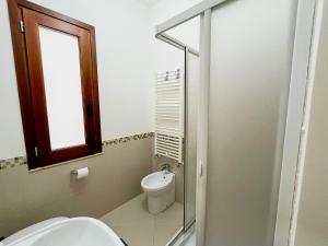 a bathroom with a toilet and a window at Casa Vacanza Acquanuova in Calatafimi