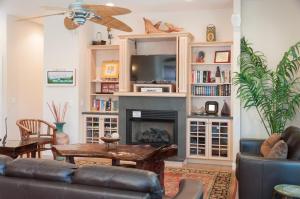 a living room with a couch and a fireplace at Reminiscent in Nags Head +27 photos