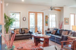 a living room with couches and a coffee table at Reminiscent in Nags Head