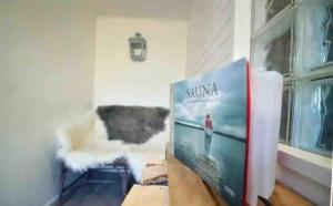 a book sitting on a table next to a window at Cottage with sauna and kayaks in Hammarland