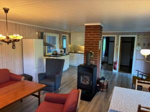 a living room with a wood stove in a kitchen at HagestadHytteutleie Eikheim in Birkeland