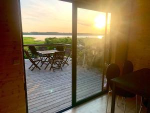 a view of a deck with a table and chairs at Cottage with sauna and kayaks in Hammarland