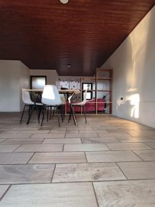 a room with a table and chairs on a tile floor at Casa Abierta Playa Juquillal 1 habitacion in Santa Cruz