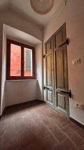 an empty room with an open door and a window at Bia Apartments Crò in Montemarcello +10 photos
