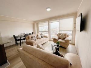 a living room with a couch and chairs and a table at Habitación privada con baño privado y smart TV in Lima