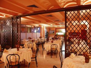 a dining room with white tables and chairs at Torreata Hotel & Residence in Palermo