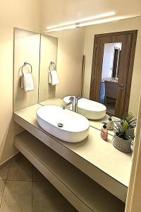 a bathroom with a sink and a mirror at Fotini in Ayia Evfimia
