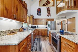 a large kitchen with wooden cabinets and granite counter tops at Brooke and Dan's Retreat -3 bedroom home plus a 2 bedroom apartment in Government Camp