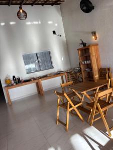 a dining room with a table and chairs and a television at Pousada Beatriz - Búzios in Búzios