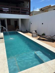 a swimming pool in the backyard of a house at Pousada Beatriz - Búzios in Búzios