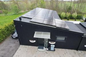 a black building with solar panels on top of it at Blackrock in Varberg