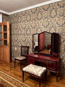 a room with a vanity and a mirror and a chair at Дом in Bavra