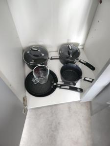 a group of pans sitting on top of a stove at Posyrooms Apartment in Stalybridge