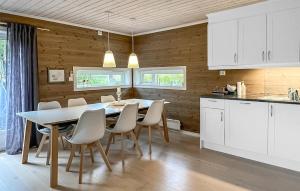 a kitchen and dining room with a table and chairs at 4 Bedroom Gorgeous Home In Edland in Vågsli